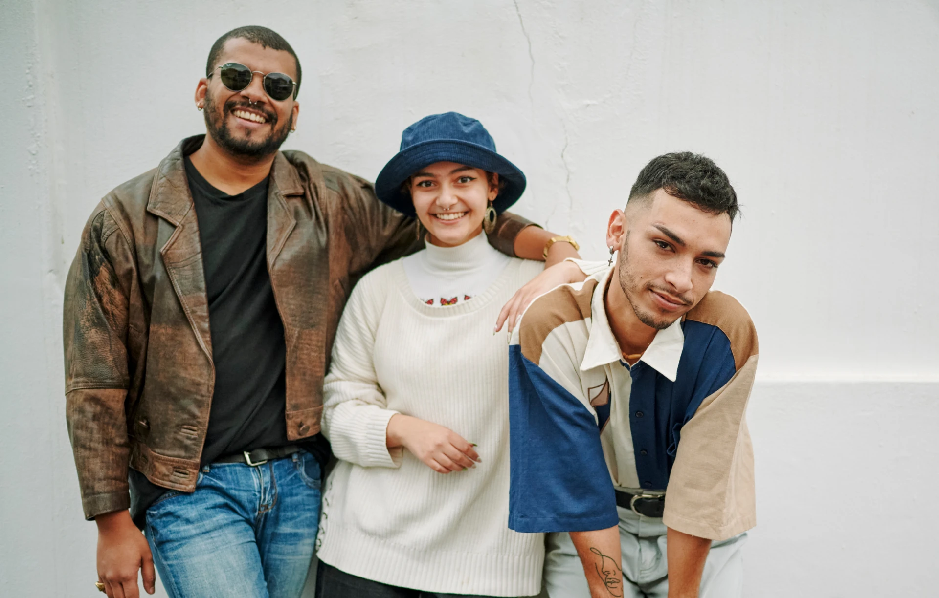 Three people posing happily outdoors