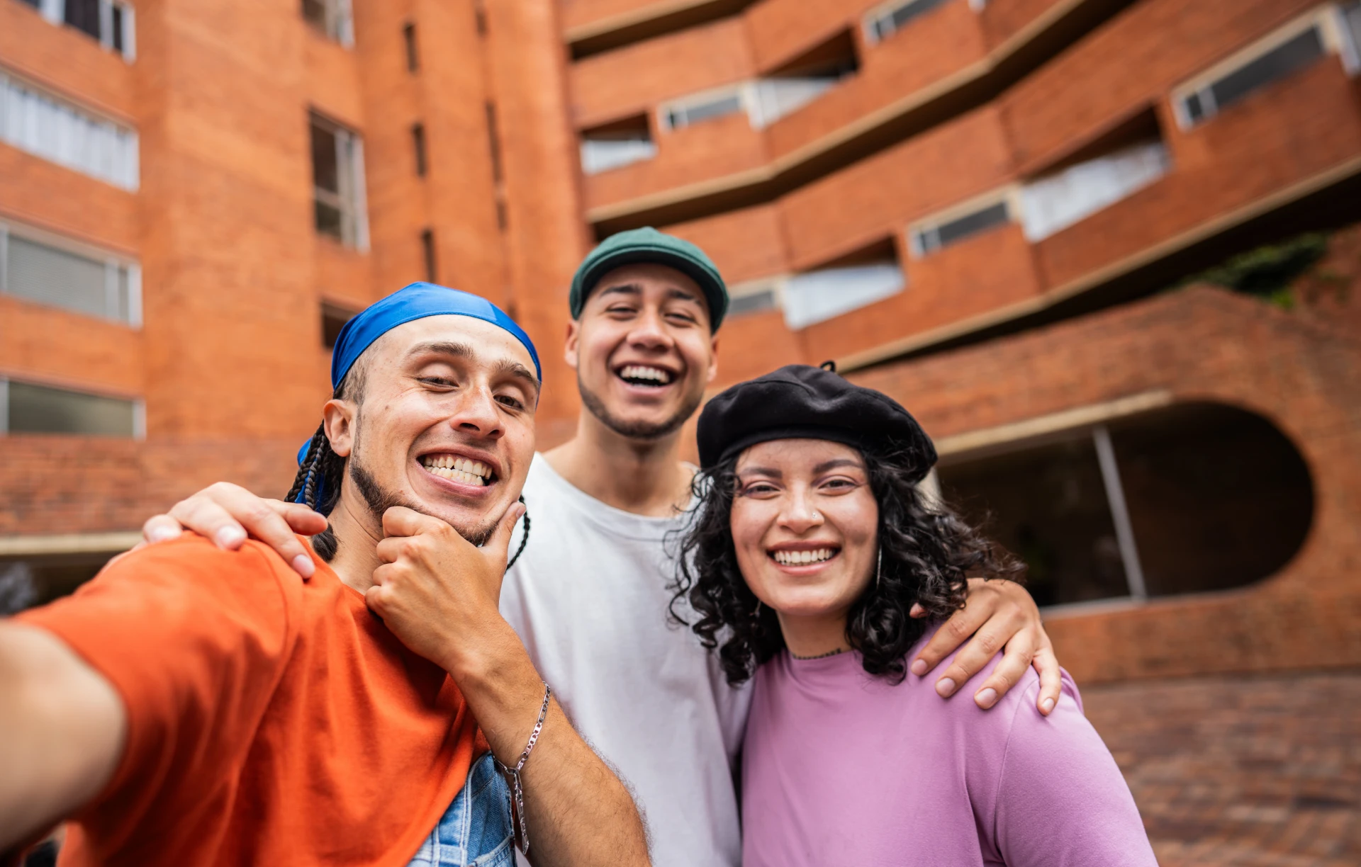 Friends smiling in front of building