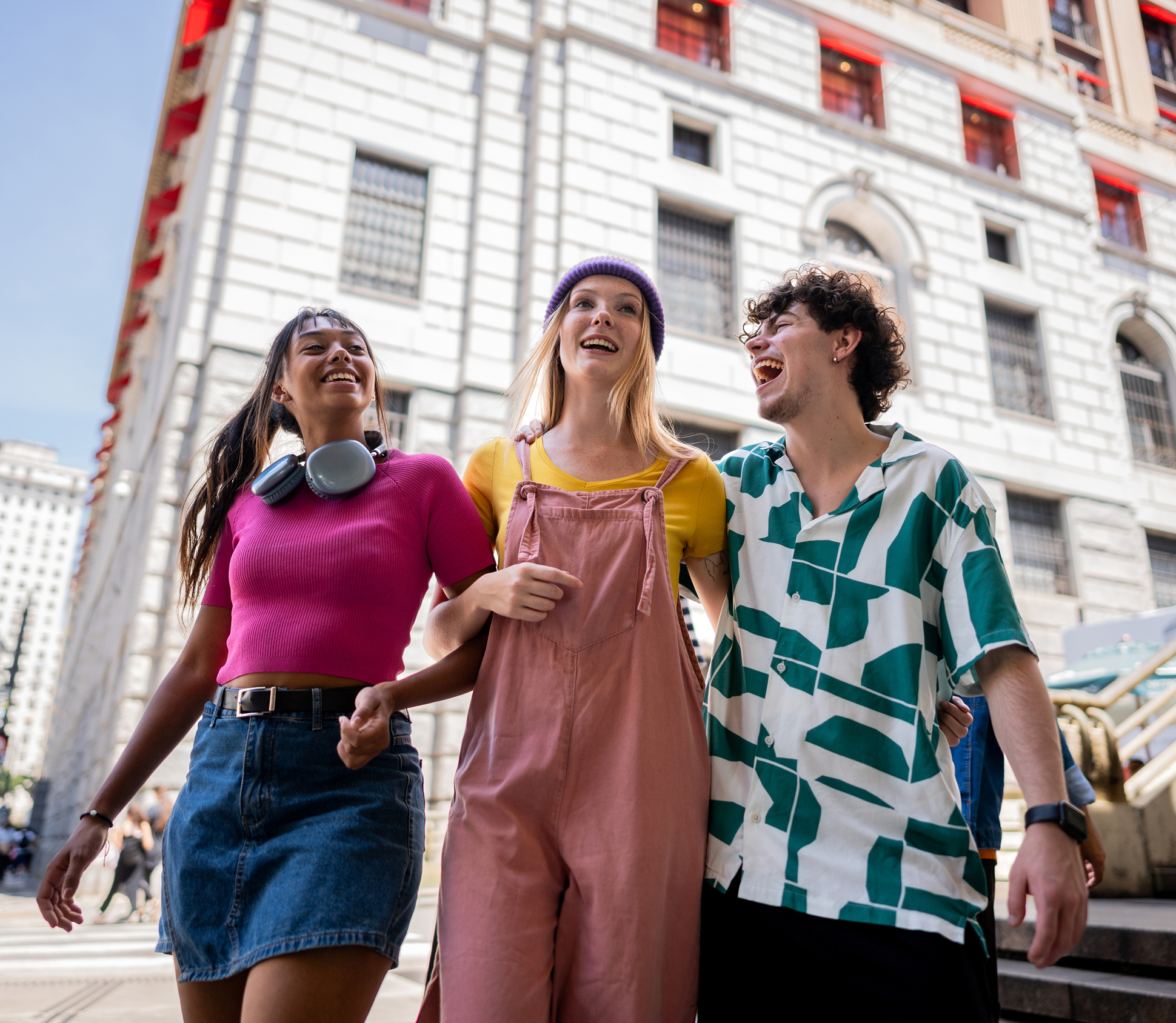 Friends laughing and walking in the city